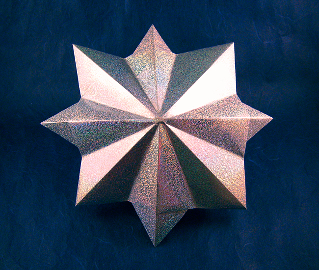 Origami Eight-pointed star by John Montroll. Folded from a square of holographic paper by Gilad Aharoni on giladorigami.com