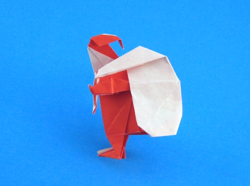 Origami Santa Claus with sack by Torimoto Norio. Folded from a square of origami paper by Gilad Aharoni on giladorigami.com